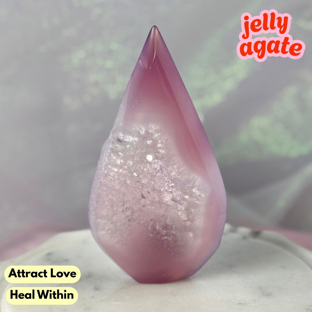 A polished teardrop-shaped jelly agate crystal with a pinkish-purple outer layer and a glittery white crystalline interior, displayed on a light surface with text overlays.