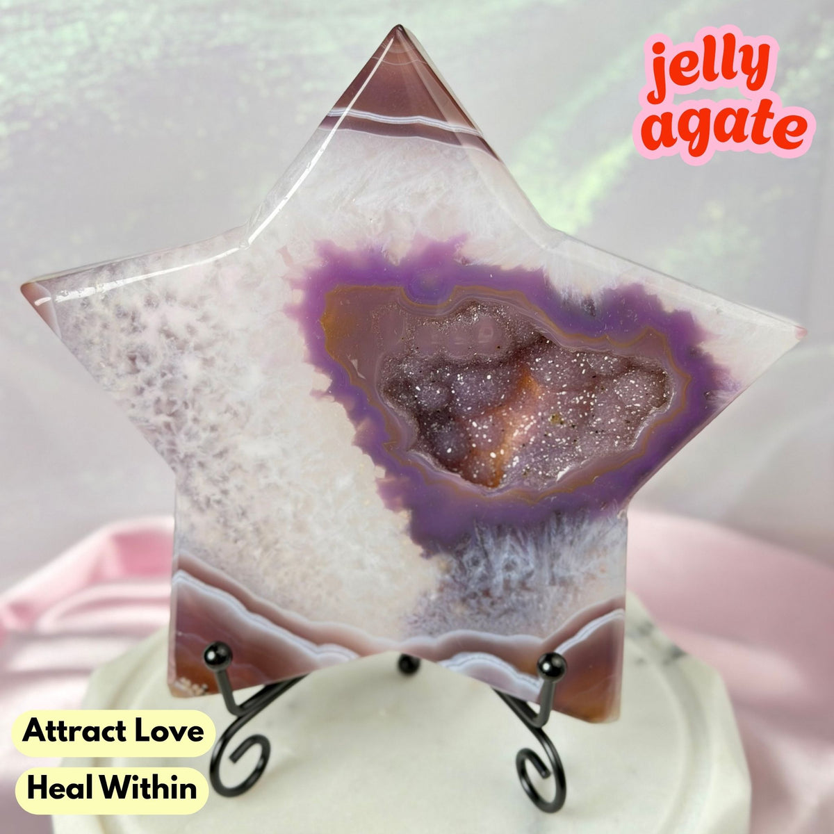 A star-shaped polished jelly agate crystal displayed on a small black stand. The agate features a purple and brown geode pattern with glittery sparkles.