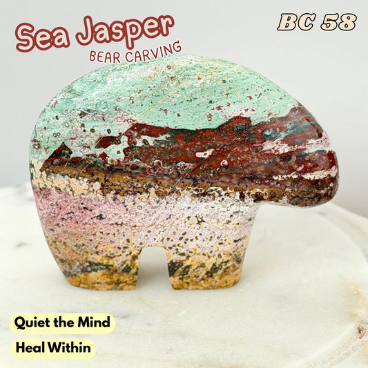 A carved sea Jasper bear figurine with a marbled pattern of mint green, red, pink, and gold, displayed on a white marble surface with text overlays.